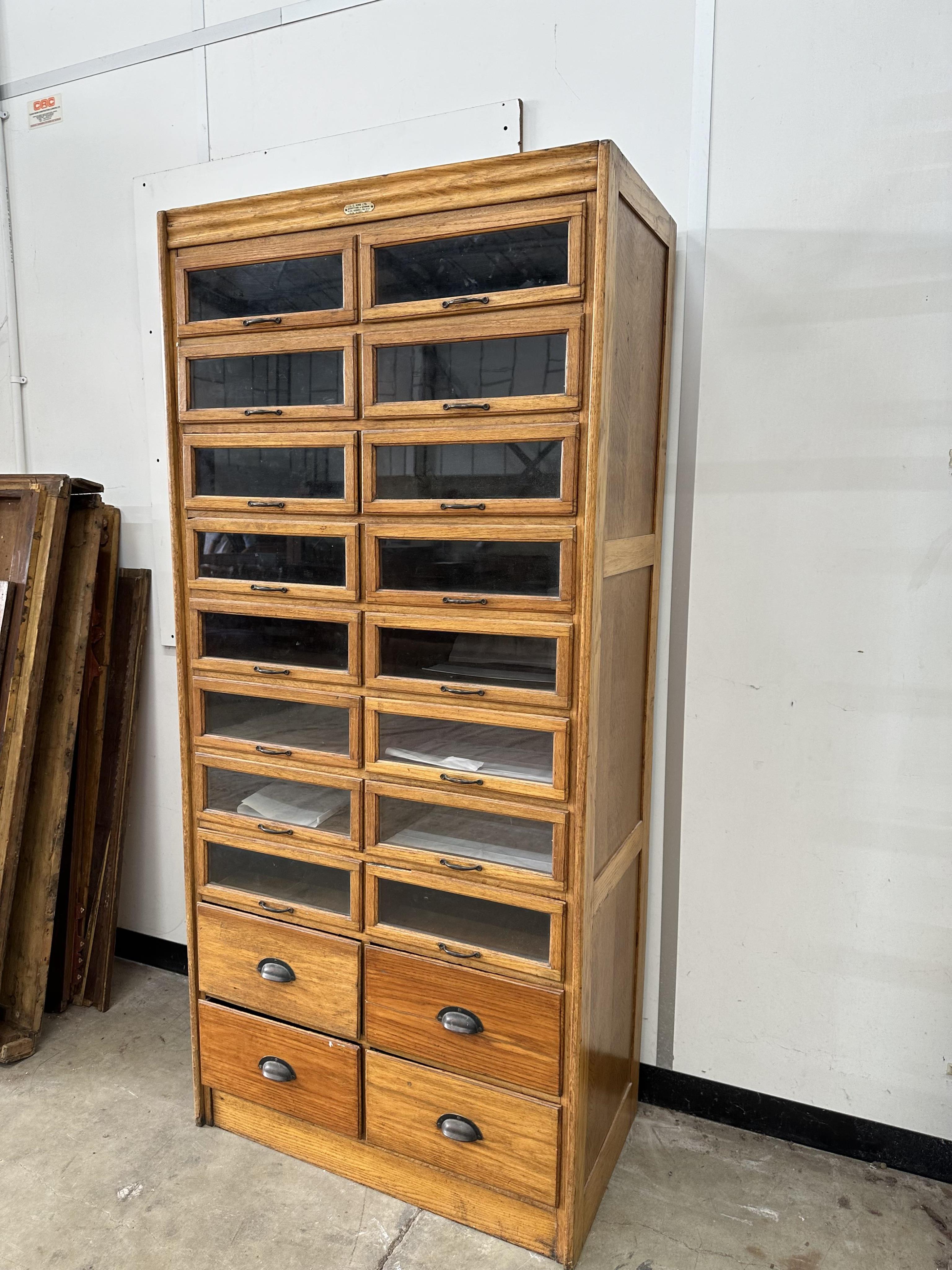A mid century oak twenty drawer haberdashery cabinet, width 91cm, depth 49cm, height 198cm. Condition - good